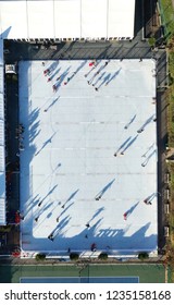 Aerial View Of People Ice Skating On An Outdoor Ice Rink