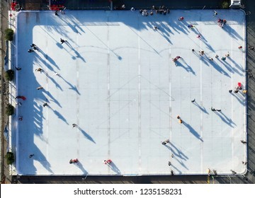 Aerial View Of People Ice Skating On An Outdoor Ice Rink