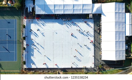 Aerial View Of People Ice Skating On An Outdoor Ice Rink