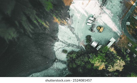 Aerial view of people in inflatable rafts floating down a river with a backdrop of trees - Powered by Shutterstock