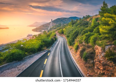 Aerial View Of Perfect Mountain Road And Beautiful Green Forest At Colorful Sunset In Summer. Dubrovnik, Croatia. Top View Of Road, Sea, Mountain, Sky. Landscape With Highway, Sea Coast, Gold Sunlight