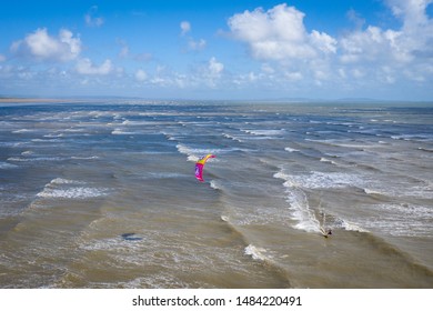 Aerial View Of Person Kite Surfing On The Water Of Pendine Sands Beach Wales Uk