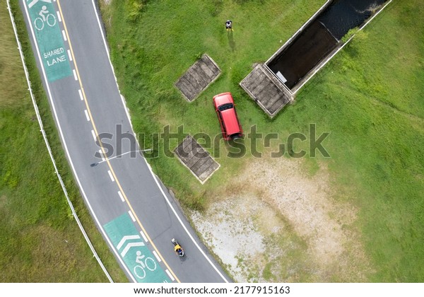 Aerial view photo high angle view top down of\
red suv car and asphalt curve\
road