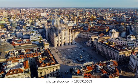 Aerial view of Piazza Duomo in front of the gothic cathedral in the center. Drone view of the gallery and rooftops during the day. Flight over the city. People in the city. Milan. Italy 2020