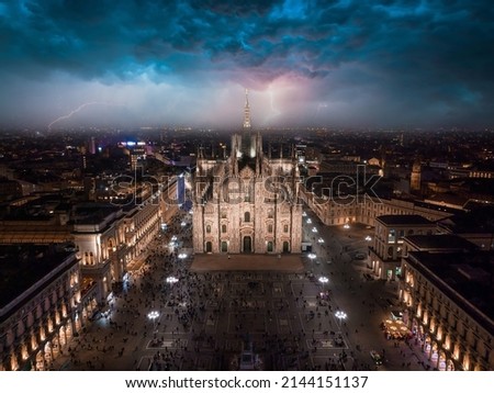 Aerial view of Piazza Duomo in front of the Duomo di Milano cathedral during heavy storm and lightening in Milan.