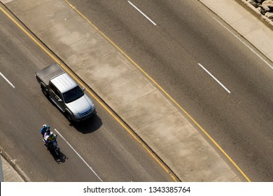 Aerial View Of A Pick Up Truck And Motorbike On An Empty Road