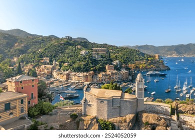 Aerial view of the picturesque coastal town of Portofino, Italy, showcasing colorful buildings, lush green hills, and yachts in the harbor. - Powered by Shutterstock