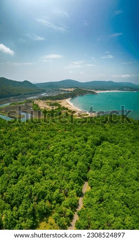 Aerial view of the picturesque curves of a river among lush vegetation that flows into the sea, Ropotamo River in Ropotamo Nature Reserve, Strandzha Mountain	
