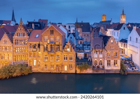 Aerial view of picturesque medieval buildings and towers of Old Town at night, Ghent, Belgium
