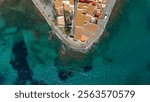 Aerial view of the picturesque town of Cadaques on the Costa Brava coast of the Mediterranean Sea in Catalonia, Spain. Santa Maria de Cadaques church and the beautiful Costa Brava shore.