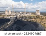 Aerial view of piles of coal and the Bayswater coal-fired power station near Muswellbrook in the Hunter Valley, NSW, Australia