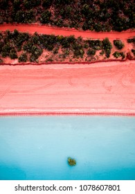 Aerial View Of A Pink Sand Beach And Red Dirt Road Next To Roebuck Bay In Broome, Western Australia.