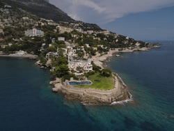 Aerial View Of Plage Mala Beach In Cap D'Ail, French Riviera Near MonteCarlo And Monaco. Drone View Of The Bay Of Mala With Its Famous Beaches In Monaco, Cap D'Ail Famous Spot With Yachts And Luxury.