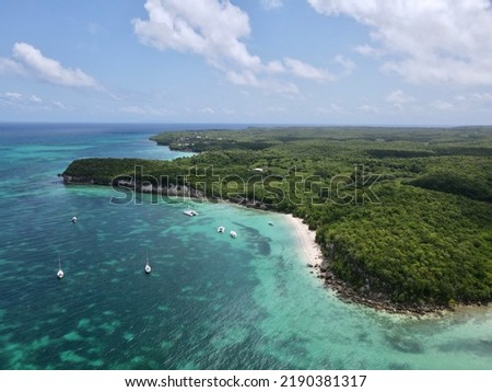 Aerial view of Plage Moustique on the island of Marie Galante in Guadeloupe. Beach and its lagoon with turquoise waters, its boats and its tropical vegetation