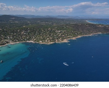 Aerial View Of Plage Ranc And Cap Taillat In French Riviera, Near Saint-Tropez. Beautiful Rocky Beach Near Coastal Path With Luxury Yachts, Turquoise And Idyllic Water. Drone View From Above France.