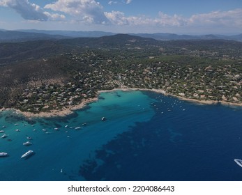 Aerial View Of Plage Ranc And Cap Taillat In French Riviera, Near Saint-Tropez. Beautiful Rocky Beach Near Coastal Path With Luxury Yachts, Turquoise And Idyllic Water. Drone View From Above France.