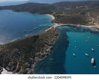 Aerial View Of Plage Ranc And Cap Taillat In French Riviera, Near Saint-Tropez. Beautiful Rocky Beach Near Coastal Path With Luxury Yachts, Turquoise And Idyllic Water. Drone View From Above France.