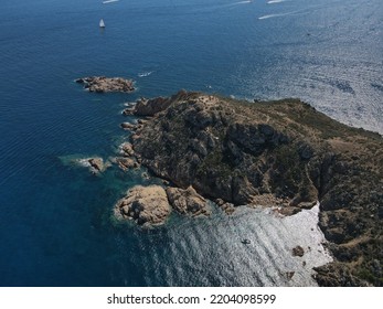 Aerial View Of Plage Ranc And Cap Taillat In French Riviera, Near Saint-Tropez. Beautiful Rocky Beach Near Coastal Path With Luxury Yachts, Turquoise And Idyllic Water. Drone View From Above France.