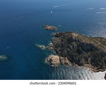 Aerial View Of Plage Ranc And Cap Taillat In French Riviera, Near Saint-Tropez. Beautiful Rocky Beach Near Coastal Path With Luxury Yachts, Turquoise And Idyllic Water. Drone View From Above France.