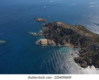 Aerial View Of Plage Ranc And Cap Taillat In French Riviera, Near Saint-Tropez. Beautiful Rocky Beach Near Coastal Path With Luxury Yachts, Turquoise And Idyllic Water. Drone View From Above France.