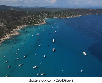 Aerial View Of Plage Ranc And Cap Taillat In French Riviera, Near Saint-Tropez. Beautiful Rocky Beach Near Coastal Path With Luxury Yachts, Turquoise And Idyllic Water. Drone View From Above France.