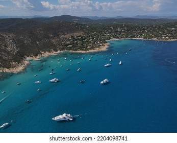 Aerial View Of Plage Ranc And Cap Taillat In French Riviera, Near Saint-Tropez. Beautiful Rocky Beach Near Coastal Path With Luxury Yachts, Turquoise And Idyllic Water. Drone View From Above France.