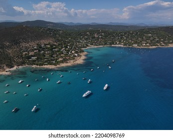 Aerial View Of Plage Ranc And Cap Taillat In French Riviera, Near Saint-Tropez. Beautiful Rocky Beach Near Coastal Path With Luxury Yachts, Turquoise And Idyllic Water. Drone View From Above France.