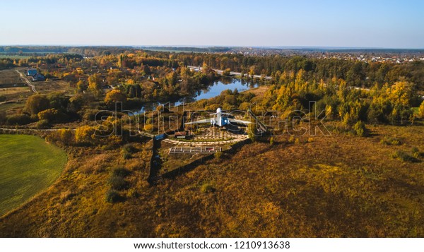 Aerial view of the plane in the autumn forest\
near the lake and beautiful landscape.\
