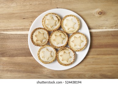 Aerial View Of A Plate Full Of Freshly Baked Mince Pies On A Wooden Kitchen Counter Background