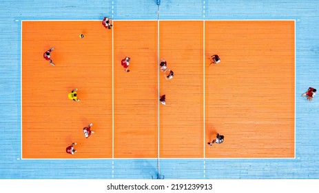 Aerial View Of Playing Volleyball. Top View Of The Volley Ball Court During Game.