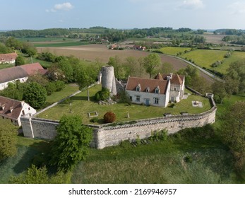 Aerial view of Poncenat castle in central France surrounded by a wall with a semi circular tower