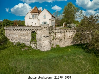 Aerial view of Poncenat castle in central France surrounded by a wall with a semi circular tower