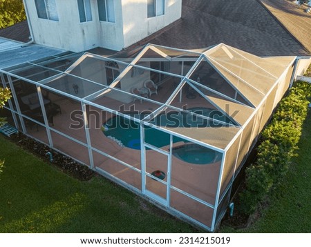 An aerial view of pool screen enclosure surrounded by trees