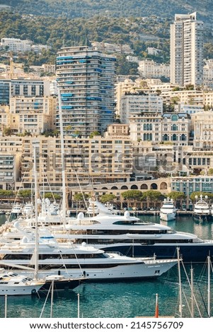Aerial view of port Hercules at sunset, mega yachts are moored in marina near yacht club of Monaco, view of city life from old town, a lot of mega yachts and boats