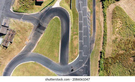 Aerial View Of A Portion Of An Empty Racetrack, With Turns And The Starting Grid Visible.