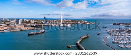 Aerial view of Portsmouth Harbor in the south of England on the Channel coast - Oil tanker passing in front of the sail-shaped Spinnaker Tower
