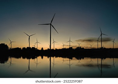 Aerial view of powerful Wind turbine farm for green energy production on beautiful sky, good environment . Wind power turbines generating clean renewable energy for sustainable development ecosystem. - Powered by Shutterstock