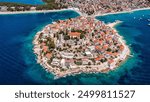 Aerial view of Primosten old town on the islet, Dalmatia, Croatia. Primosten, Sibenik Knin County, Croatia. Resort town on the Adriatic coast. Aerial view of adriatic town Primosten, Croatia