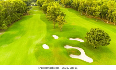 An aerial view of a pristine golf course with sand traps and lush greenery