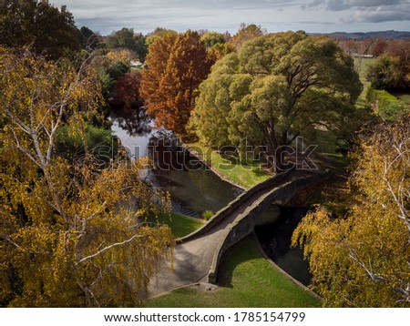 Aerial view of a public park full of trees with a bridge during autumn. Windsor Park, Hastings, New Zealand
