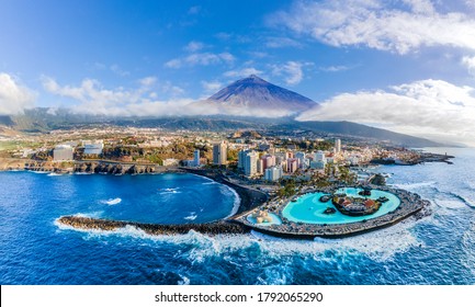 Aerial view with Puerto de la Cruz, in background Teide volcano, Tenerife island, Spain
				