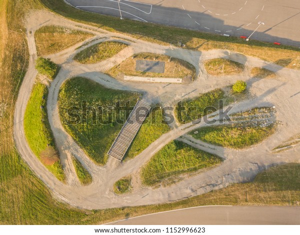 Aerial\
view of pump track traffic lanes in\
Switzerland