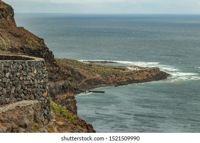 Aerial View Of Punta Llana, Where Is The Ermita De Nuestra Senora De Guadalupe At La Gomera. Hiking Trail Descending To The Coastal Plateau. Long Focus Lens. Canary Islands.