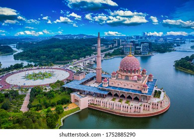 Aerial View Of Putra Mosque with Putrajaya City Centre with Lake at sunset in Putrajaya, Malaysia.