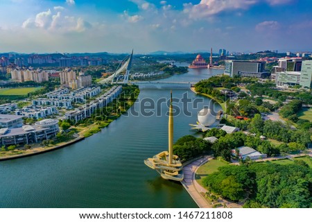Aerial View Of Putrajaya Lake With Monument Tower And Putrajaya Bridge View