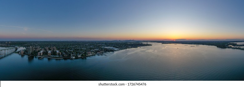 Aerial View Of Queens In New York City At Sunset With The George Washington Bridge In The Background.