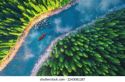 Aerial view of rafting boat or canoe in mountain river and forest. Recreation  camping and sport lifestyle