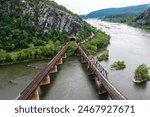 Aerial View of A Rail Bridge in Harpers Ferry West Virginia Leading to a Tunnel in A Mountain