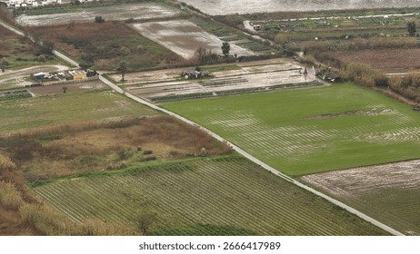 Aerial view of rain swept patchwork fields captures serene agricultural symphony, connected to Plough Mondays rural reawakening spirit