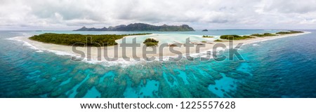 Aerial view of Raivavae island with sandy beaches, coral reef and green islets motu in azure turquoise blue lagoon. Tubuai Islands (Austral Islands), French Polynesia, Oceania. Tahiti and her islands 